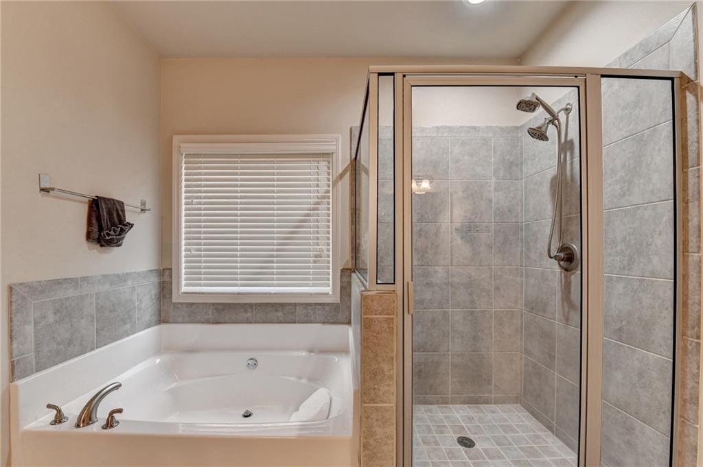 2583 Madison Mae Lane Grayson, GA 30017 - Photo 27 of 43 a bathroom with a bathtub and a shower