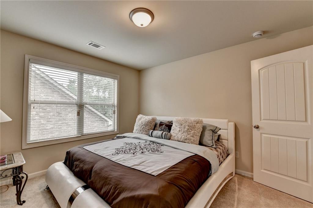 2583 Madison Mae Lane Grayson, GA 30017 - Photo 28 of 43 a bedroom with a bed and a couch