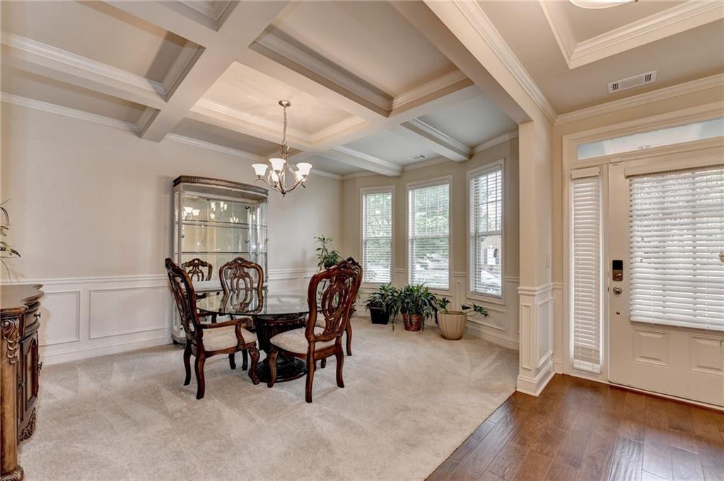2583 Madison Mae Lane Grayson, GA 30017 - Photo 3 of 43 a dining room with furniture a chandelier and wooden floor