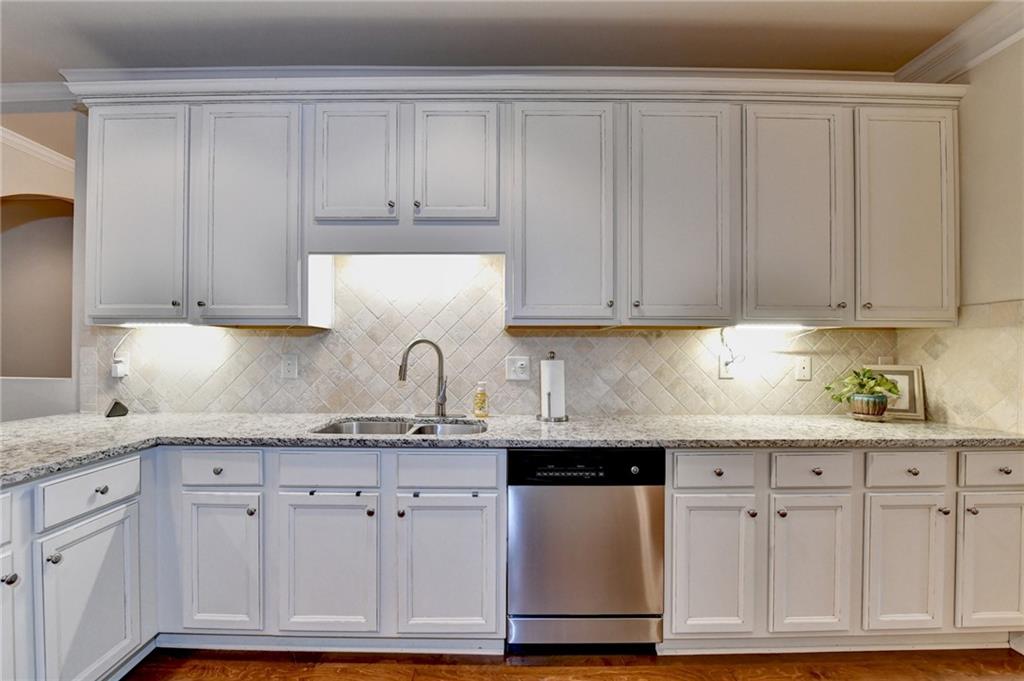 2583 Madison Mae Lane Grayson, GA 30017 - Photo 9 of 43 a kitchen with granite countertop cabinets and white appliances