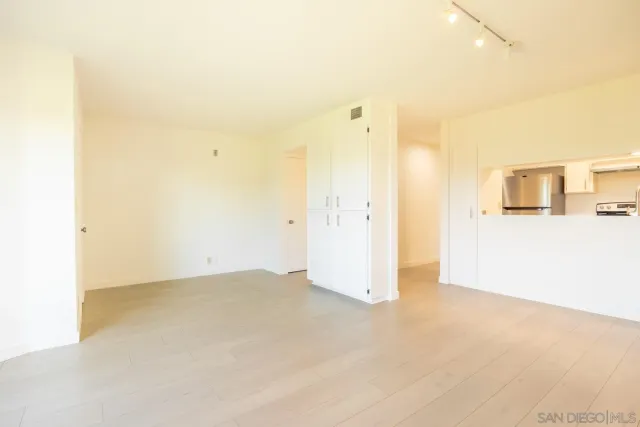 front view of a building with a garden and plants