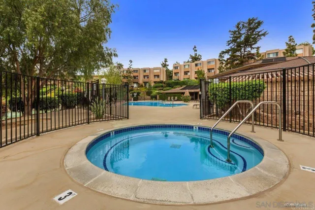 a view of a swimming pool with an outdoor seating and a yard