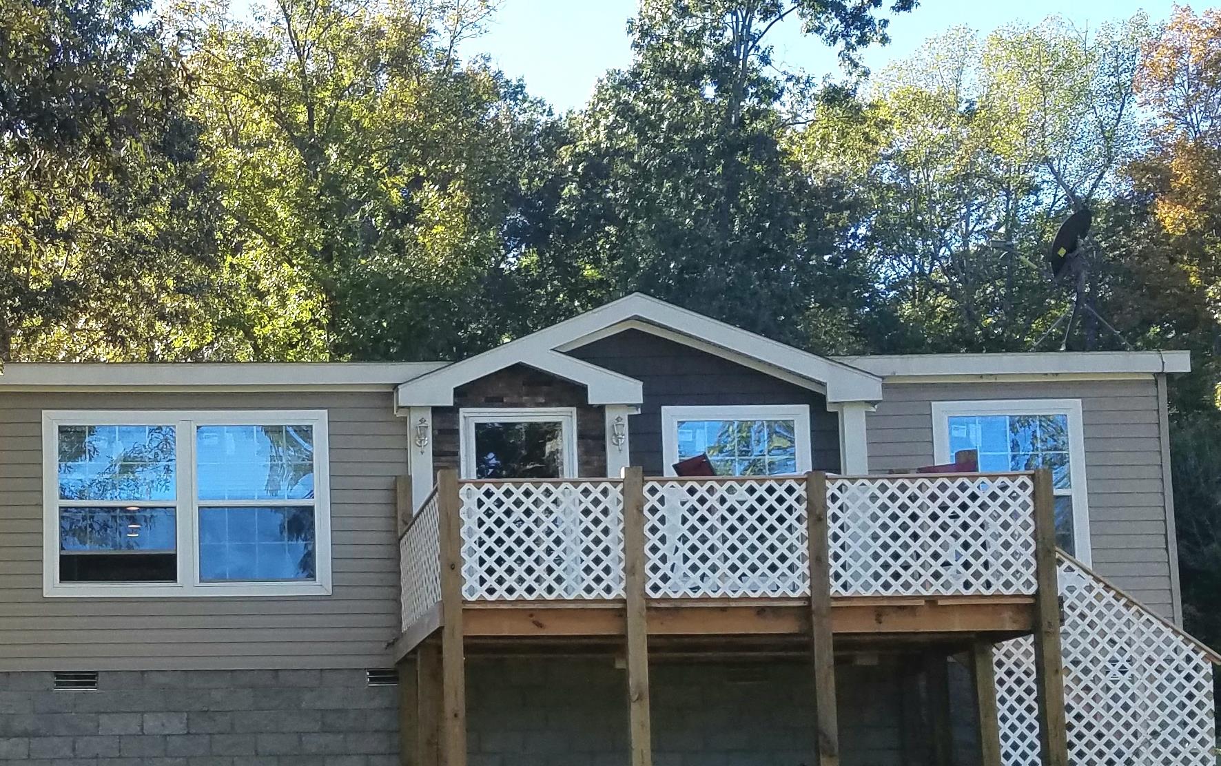 6363 Gordon Lawrence Road Santa Fe, TN 38482 - Photo 18 of 20 a view of a house with a deck and furniture