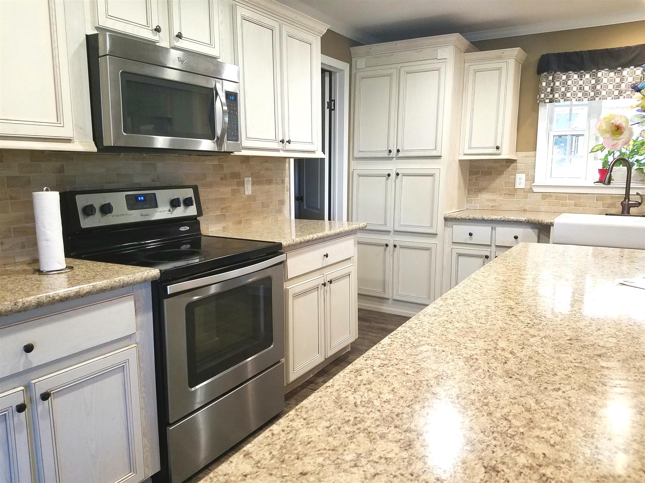 6363 Gordon Lawrence Road Santa Fe, TN 38482 - Photo 3 of 20 a kitchen with stainless steel appliances granite countertop a stove microwave and sink
