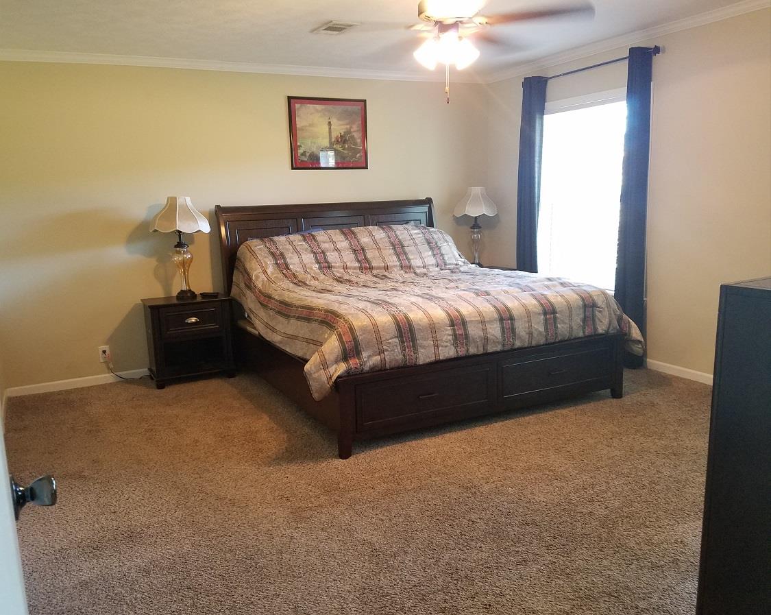 6363 Gordon Lawrence Road Santa Fe, TN 38482 - Photo 8 of 20 a bed sitting in a bedroom next to a window