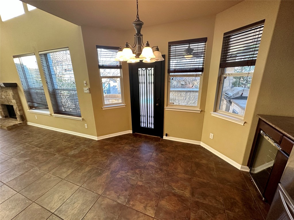 3713 Broadwinged Hawk Cove Austin, TX 78738 - Photo 15 of 37 a view of an empty room with window and refrigerator