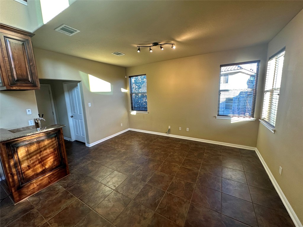 3713 Broadwinged Hawk Cove Austin, TX 78738 - Photo 16 of 37 a view of an empty room with a fireplace and a window