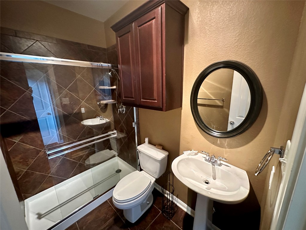 3713 Broadwinged Hawk Cove Austin, TX 78738 - Photo 17 of 37 a bathroom with a toilet a sink and a mirror