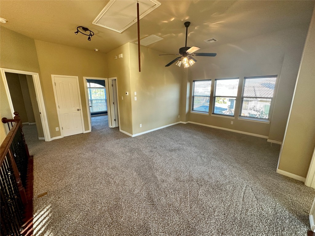 3713 Broadwinged Hawk Cove Austin, TX 78738 - Photo 19 of 37 a view of a livingroom with a ceiling fan and window