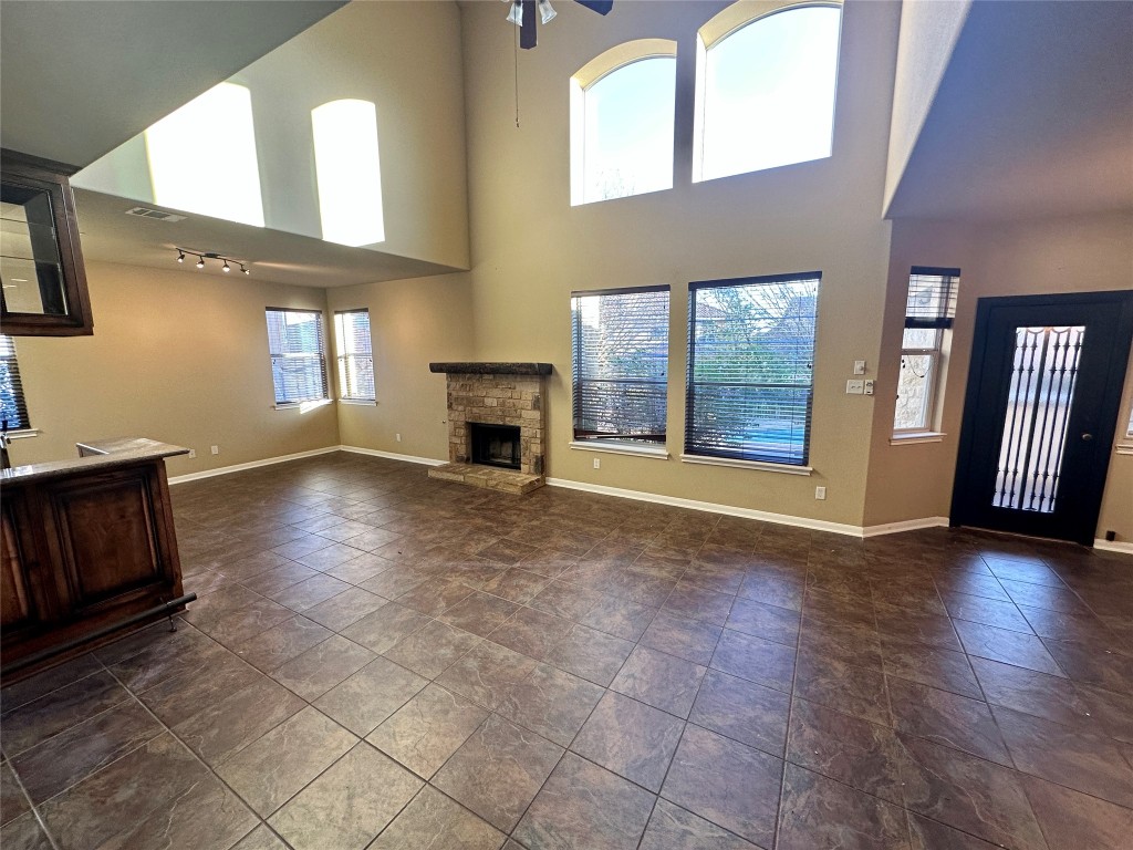 3713 Broadwinged Hawk Cove Austin, TX 78738 - Photo 8 of 37 a view of an empty room with window and fireplace