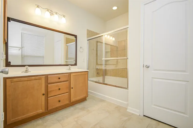 a bathroom with a granite countertop sink mirror and