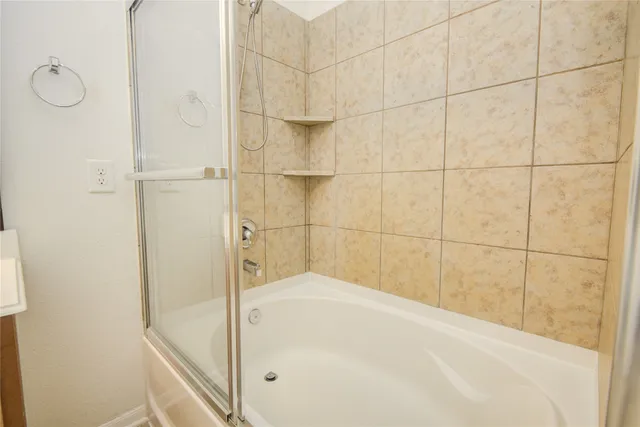 a bathroom with a bathtub and shower