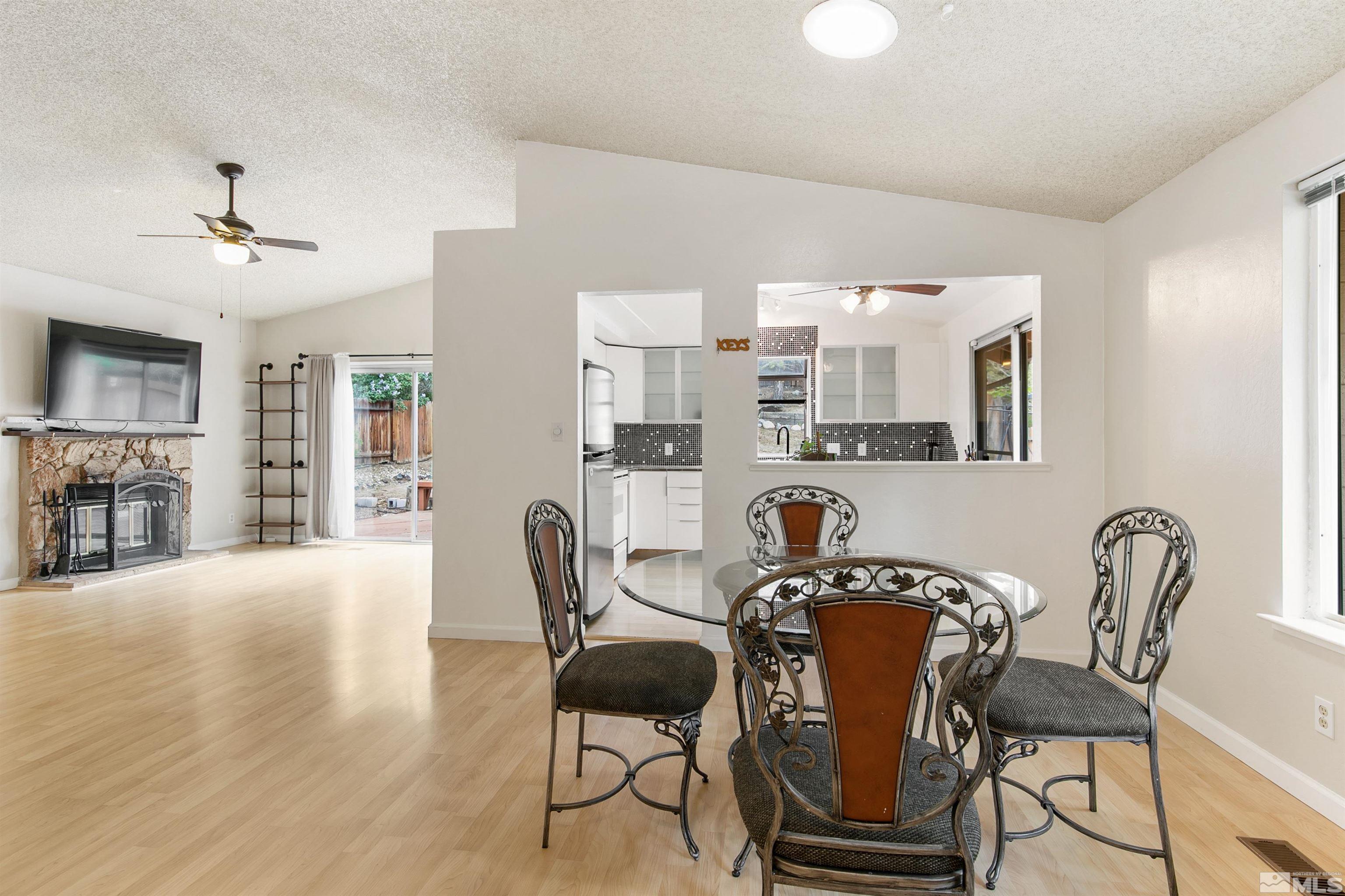 1394 Ambassador Drive Reno, NV 89523 - Photo 5 of 28 a view of a dining room with furniture and wooden floor