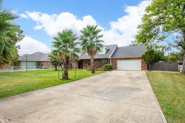 a front view of house with yard and green space