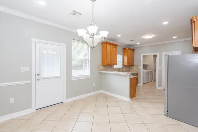a view of a kitchen with a refrigerator and a stove