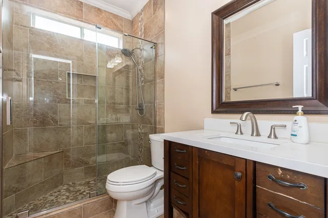 a bathroom with a sink toilet and shower
