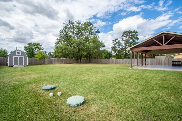 a backyard of a house with table and chairs