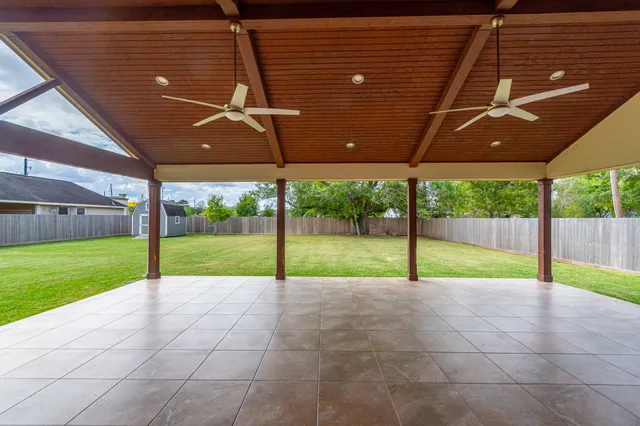 a view of an house with backyard and porch