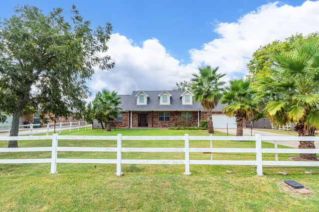 a house view with a big yard and plants