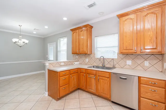 a kitchen with stainless steel appliances granite countertop a sink and a stove