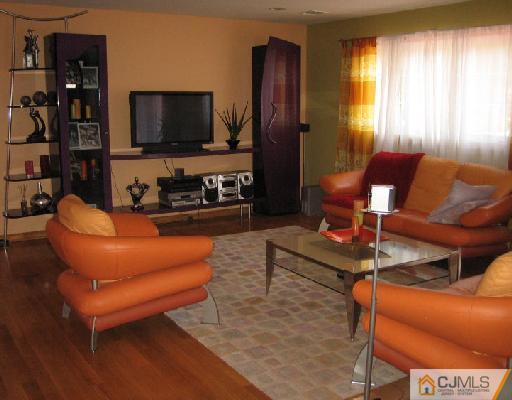 34 Kimberly Road Colonia, NJ 07067 - Photo 2 of 8 a living room with furniture and a flat screen tv