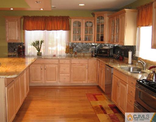 34 Kimberly Road Colonia, NJ 07067 - Photo 4 of 8 a kitchen with stainless steel appliances granite countertop a sink stove and cabinets