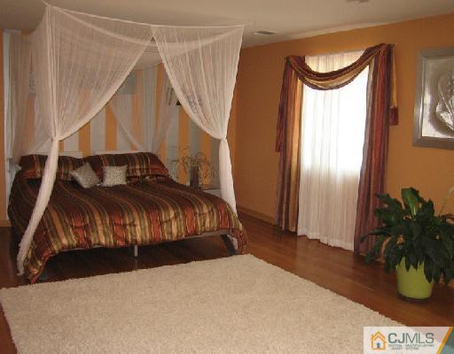 34 Kimberly Road Colonia, NJ 07067 - Photo 6 of 8 a bedroom with a bed and a potted plant