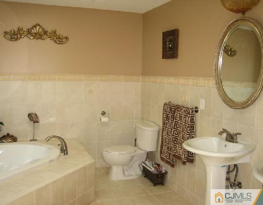 34 Kimberly Road Colonia, NJ 07067 - Photo 7 of 8 a bathroom with a sink toilet and a mirror