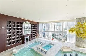 a living room with fireplace furniture and a large window