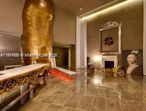 a living room with furniture a fireplace and potted plant