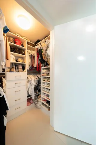 a view of walk in closet with clothes