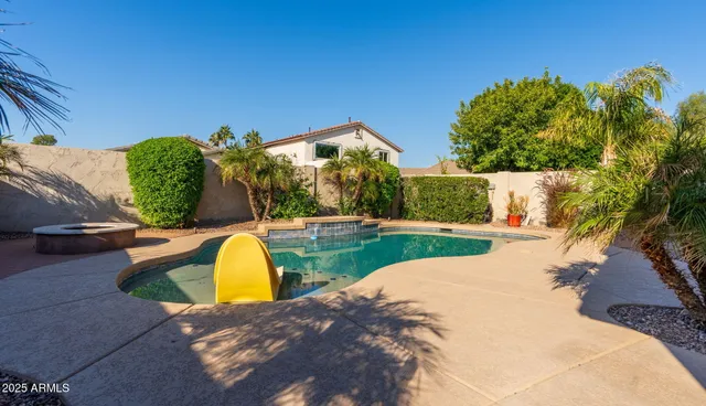 a view of a swimming pool with a yard
