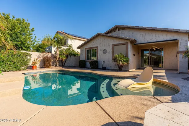 a view of a swimming pool with a chairs