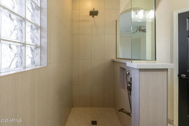 a bathroom with a glass door shower