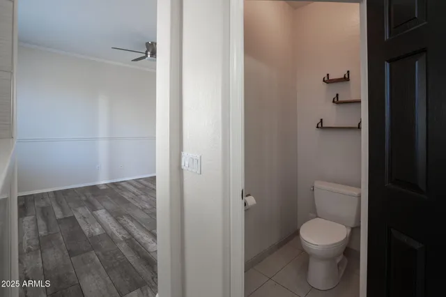 a bathroom with a granite countertop toilet and a shower