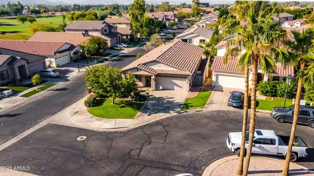 an aerial view of a house with garden space and street view