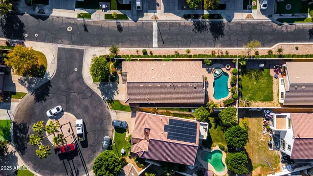 an aerial view of a house with a garden and potted plants