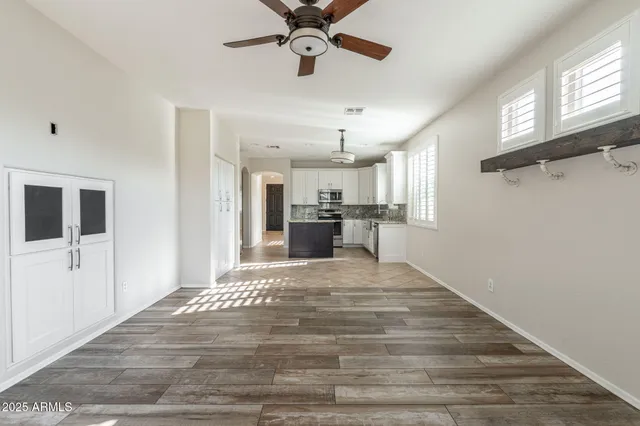 a view of a kitchen with a sink and cabinet with wooden floor