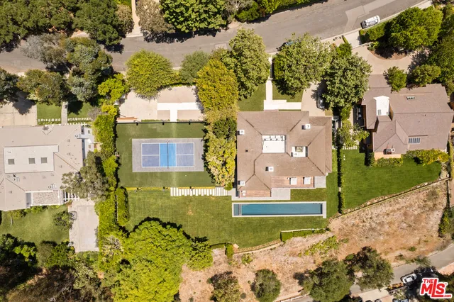 an aerial view of a house with a yard