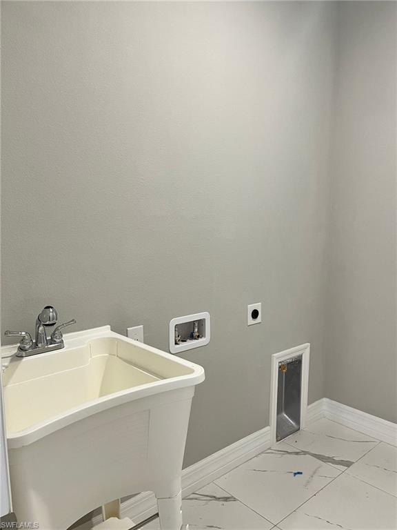 3115 58th Street West Lehigh Acres, FL 33971 - Photo 11 of 14 a bathroom with a bathtub