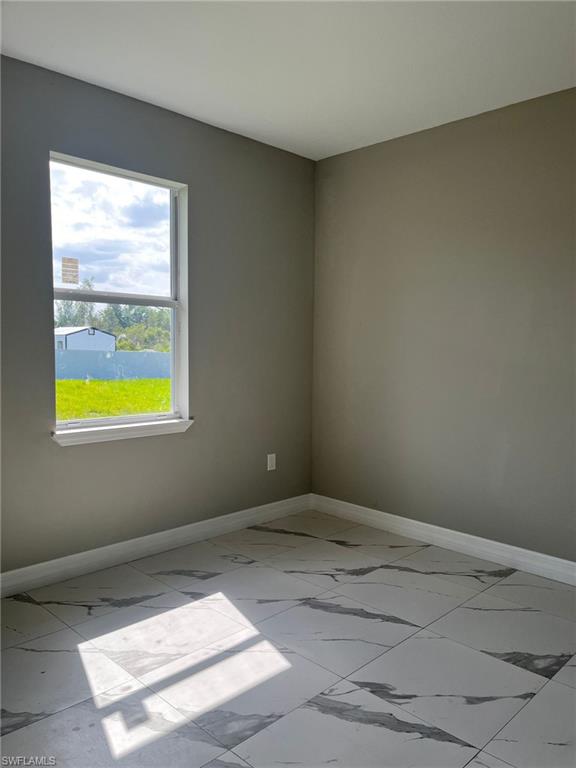 3115 58th Street West Lehigh Acres, FL 33971 - Photo 12 of 14 a view of an empty room and window