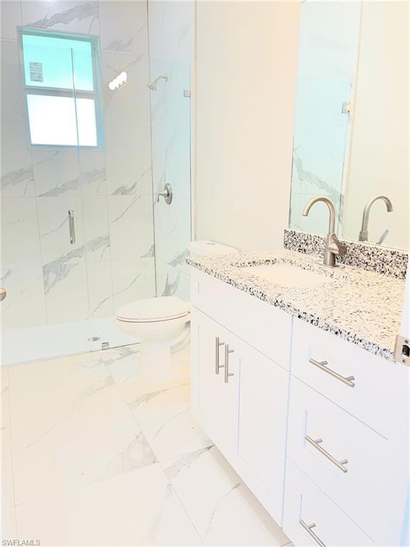 3115 58th Street West Lehigh Acres, FL 33971 - Photo 13 of 14 a bathroom with a sink and a mirror