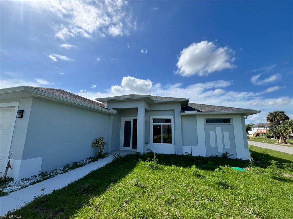 3115 58th Street West Lehigh Acres, FL 33971 - Photo 14 of 14 a backyard of a house with table and chairs