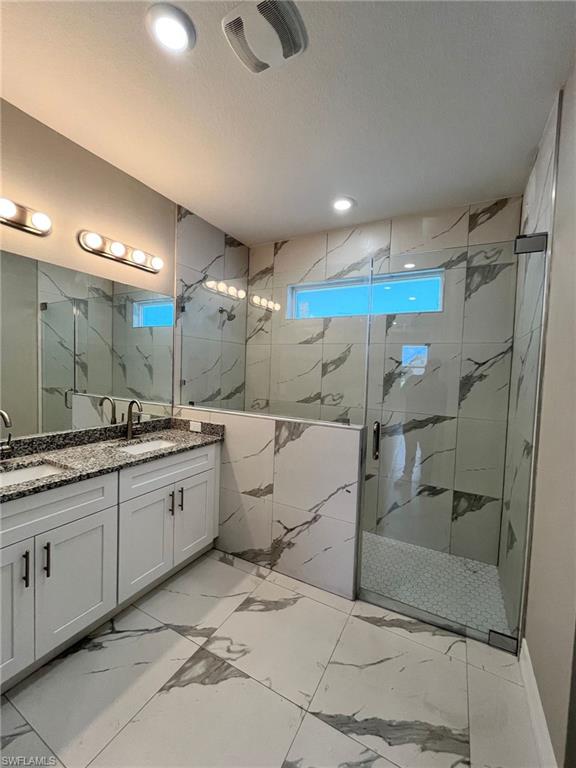 3115 58th Street West Lehigh Acres, FL 33971 - Photo 5 of 14 a bathroom with a sink mirror and a shower