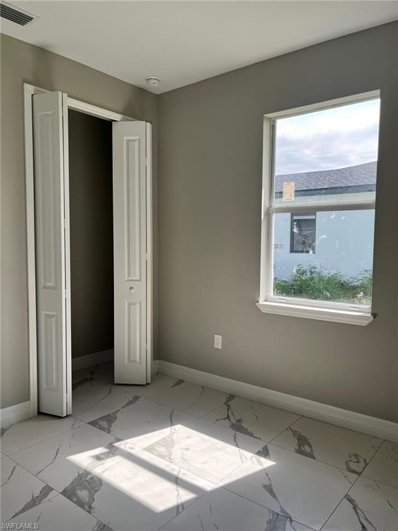 3115 58th Street West Lehigh Acres, FL 33971 - Photo 10 of 14 a view of a room that has a window in it