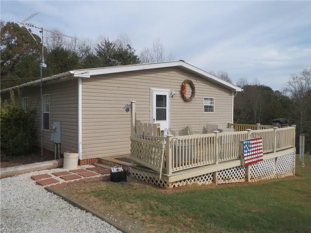 123 Industrial Road Elkin, NC 28621 - Photo 3 of 27 Side view of home. Gravel drive and walkway leading to deck.