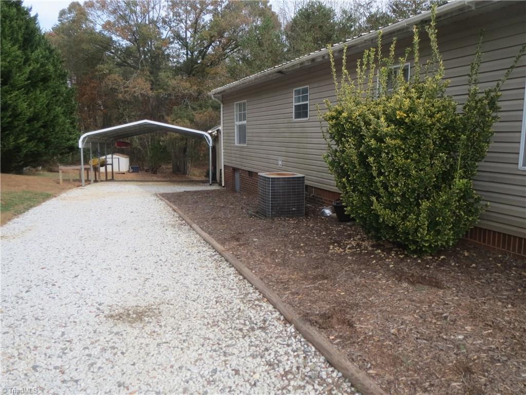 123 Industrial Road Elkin, NC 28621 - Photo 21 of 27 Gravel driveway leading to two-bay carport.