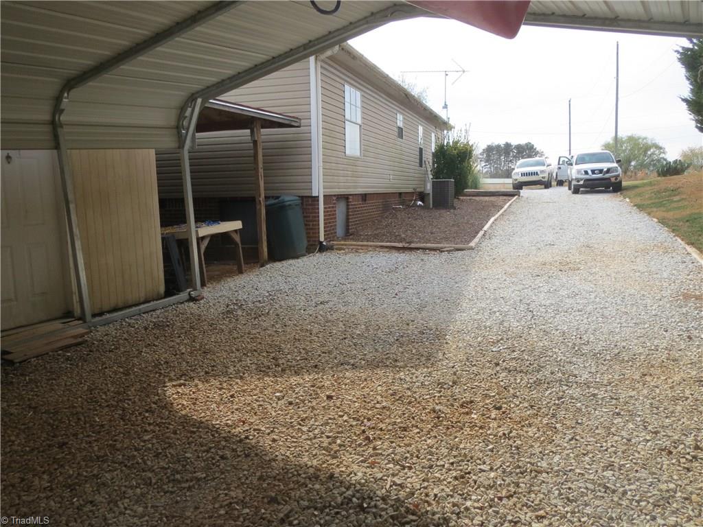 123 Industrial Road Elkin, NC 28621 - Photo 22 of 27 Two-bay carport leads to workshop.