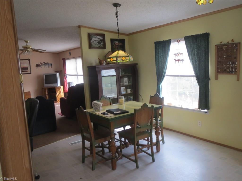 123 Industrial Road Elkin, NC 28621 - Photo 6 of 27 Kitchen with vinyl floor and breakfast nook looking toward living room.