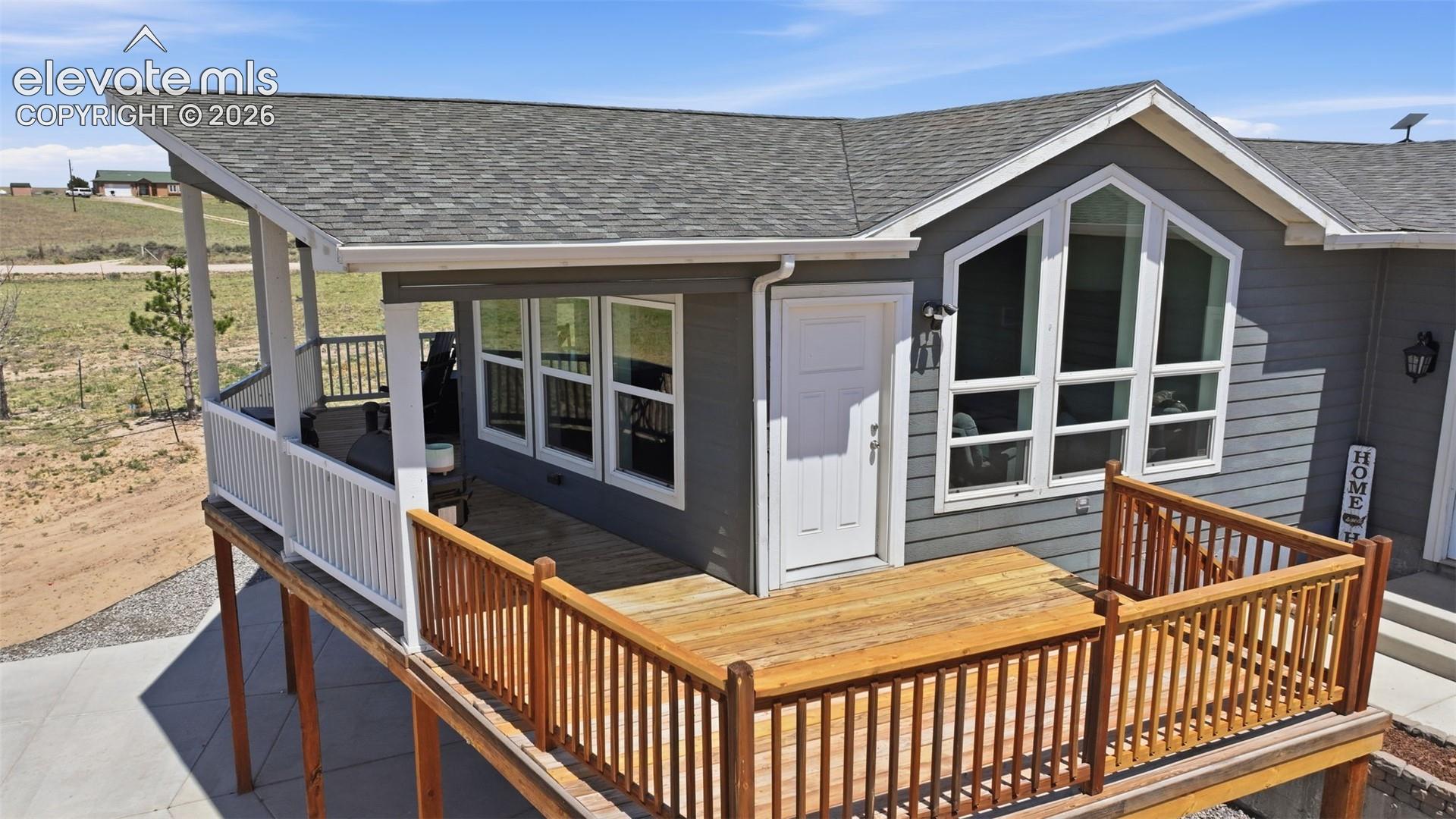23335 Sanborn Road Calhan, CO 80808 - Photo 5 of 28 Covered upper deck with panoramic views and unforgettable Colorado sunsets, perfect for relaxing or entertaining friends and family